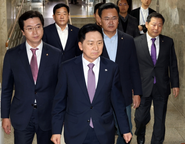 People Power Party Chairman Kim Gi-hyeon (center, front row) and high-ranking party officials walk down the aisle at the National Assembly as the ruling party started an emergency meeting Sunday afternoon. (Yonhap)