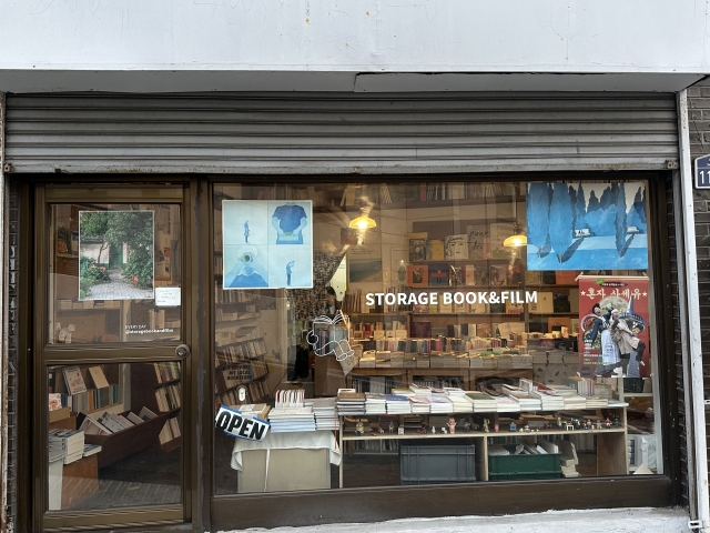 Artistic posters and an array of books seen through the window of the indie bookstore Storage Book & Film in the Haebangchon neighborhood of Yongsan-gu, Seoul. ((Moon Joon-hyun/The Korea Herald)