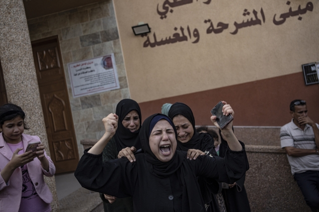 Palestinians mourn their relatives killed in the Israeli bombardment of the Gaza Strip, in the hospital in Khan Younis, Saturday. (AP-Yonhap)