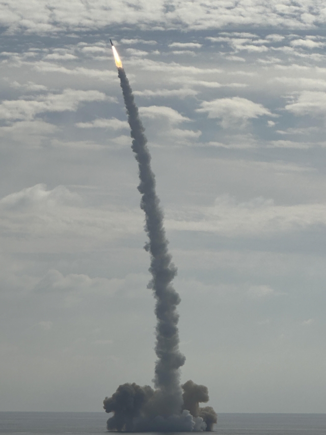 A solid-fuel space launch vehicle developed by the state-run Agency for Defense Development and equipped with a small satellite manufactured by Hanwha Systems takes off from a barge in waters off Jeju Island on Monday afternoon. (Hanwha Systems)