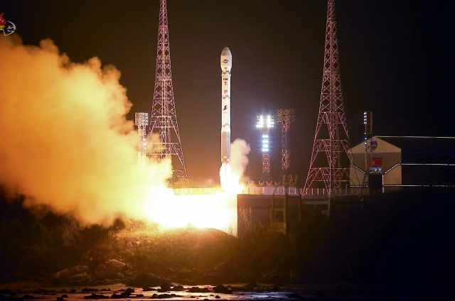 This photo on Nov. 22, shows the North launching a military spy satellite, called the Malligyong-1, on a new type of Chollima-1 rocket the previous day. (KCNA)