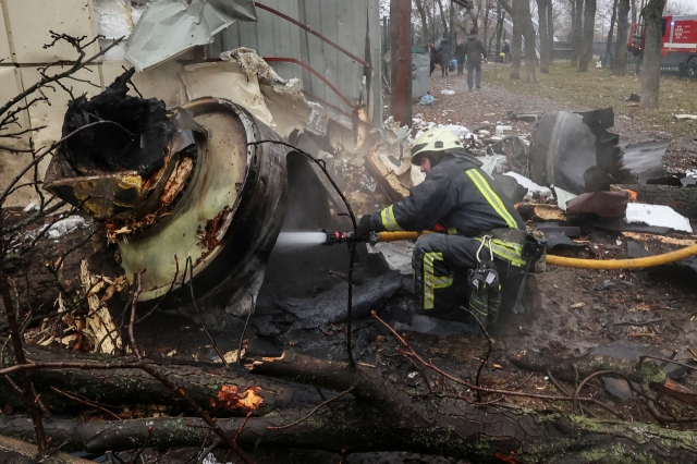 A firefighter extinguishes remains of an unidentified missile, which Ukrainian authorities claimed to be made in North Korea, at a site of a Russian strike, amid Russia's attack on Ukraine, in Kharkiv, Ukraine on Jan.2. (Reuters)