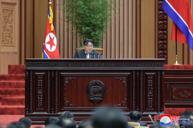 This photo, carried by North Korea's official Korean Central News Agency on Tuesday, shows the North Korean leader Kim Jong-un delivering a speech at the 10th session of the 14th Supreme People's Assembly held in Pyongyang on Monday. (Yonhap)