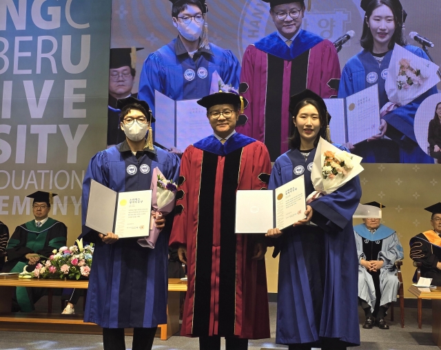 Starbucks Korea employees pose for a photo during the 2024 graduation ceremony at Hanyang Cyber University in Seoul, Saturday. (Starbucks Korea)