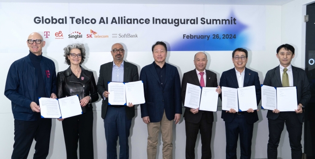 From left: Deutsche Telekom’s CEO Tim Hottges and board member Claudia Nemat; e& group CEO Hatem Dowidar; SK Group Chairman Chey Tae-won; Singtel group CEO Yuen Kuan Moon; SK Telecom CEO Ryu Young-sang; and SoftBank’s CISO Tadashi Iida pose for photos at SK Telecom's booth at the Mobile World Congress 2024, in Barcelona, Spain, Monday. (SK Telecom)