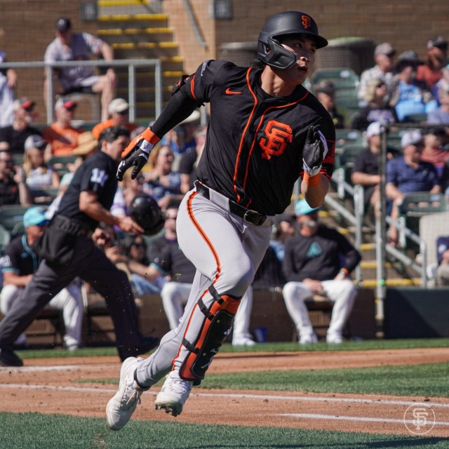 Lee Jung-hoo of the San Francisco Giants tosses his bat after hitting a groundball back to the mound against the Cleveland Guardians during a Major League Baseball spring training game at Goodyear Ballpark in Goodyear, Arizona, on Sunday. (AP)