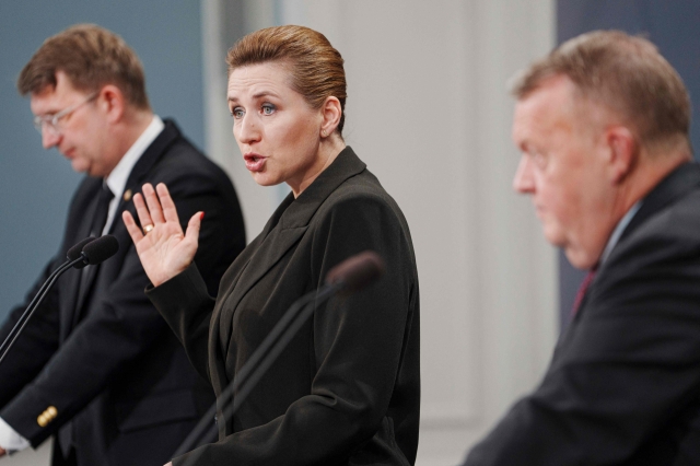 Denmark's Prime Minister Mette Frederiksen (center), Deputy Prime Minister and Minister of Defense Troels Lund Poulsen (left) and Foreign Minister Lars Loekke Rasmussen participate in a press conference on strengthening the Armed Forces, on Wednesday, in Copenhagen. (AFP)