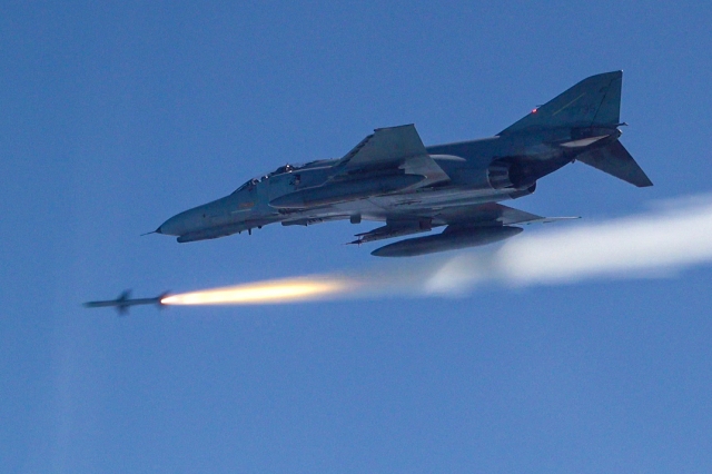 This photo, provided Friday, shows an F-4E fighter jet firing an air-to-air missile during live-fire drills over waters off the west coast from Monday to Friday. (Air Force)