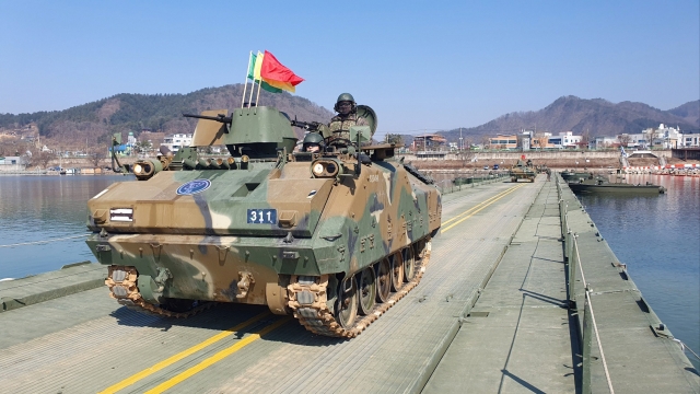 An armored tank crosses a makeshift bridge during river-crossing drills held in Hwacheon, 89 kilometers northeast of Seoul on March 13, 2024. (Korean Army 3rd Corps)