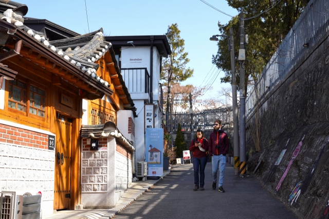 Visitors walk around Bukchon-ro-5-gil, in Seoul, Monday. (Lee Si-jin/The Korea Herald)