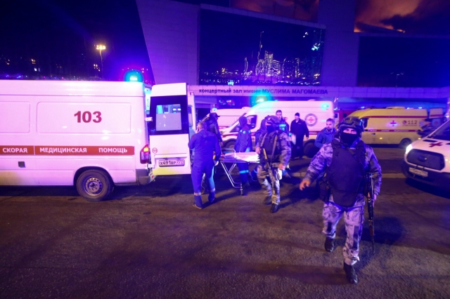 Medics and law enforcement officers are seen outside the Crocus City Hall concert hall following the shooting incident in Krasnogorsk, outside Moscow, on Friday. (AFP-Yonhap)