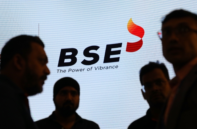 People stand in front of a logo of Bombay Stock Exchange in Mumbai, India, 21 August, 2023. (Getty Images)