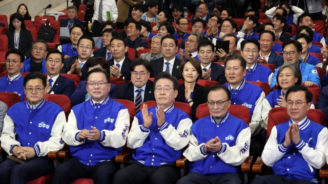 Members of the main opposition Democratic Party of Korea cheer at the National Assembly in Seoul, after exit poll results for the 2024 general election were announced at 6 p.m. on Wednesday. (Yonhap)