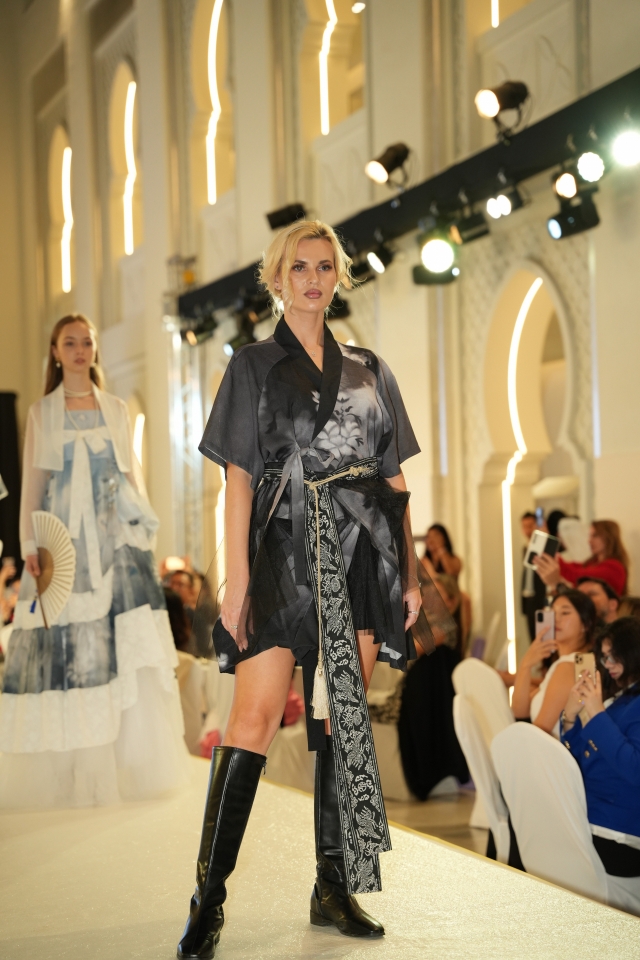 A model wearing a Korean fashion designer's collection poses for a photo during a fashion show held as part of K-Culture Festival 2024 Dubai at the Arjaan by Rotana Hotel in Dubai's Media City, Friday. The festival, which showcased fashion combining artificial intelligence and blockchain technology, runs until Saturday. (Yonhap)