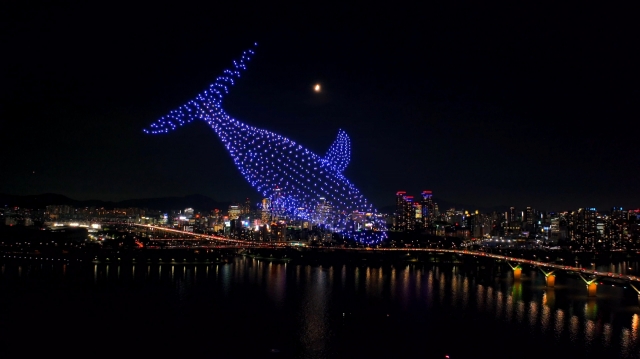 Drones illuminate the night sky during a drone light show in a park along the Han River in Seoul last year. (Seoul Metropolitan Government)