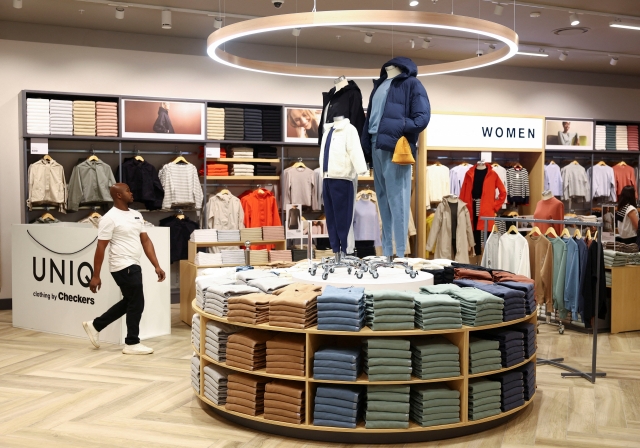 A worker walks at UNIQ clothing store, owned by one of South Africa's biggest supermarket retailer Shoprite Holdings during its opening at Sandton mall in Sandton, South Africa, on Wednesday. (Reuters)