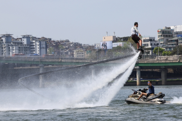 A man rides a Flyboard on the Han River, near Jamwon-dong, Seocho-gu, southern Seoul, April 14. (Yonhap)