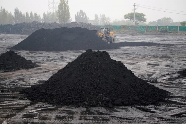 An excavator sift through dunes of low-grade coal near a coal mine in Pingdingshan, Henan province, China November 5, 2021. (Reuters)