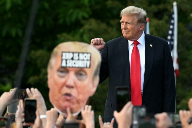 Former US President and Republican presidential candidate Donald Trump walks on stage as he arrives for a campaign rally in the South Bronx in New York City on Thursday. (AFP-Yonhap)