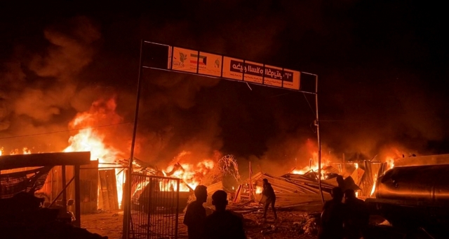 Fire rages following an Israeli strike on an area designated for displaced Palestinians in Rafah in the southern Gaza Strip, in this still picture taken from a video, Sunday. (Reuters)