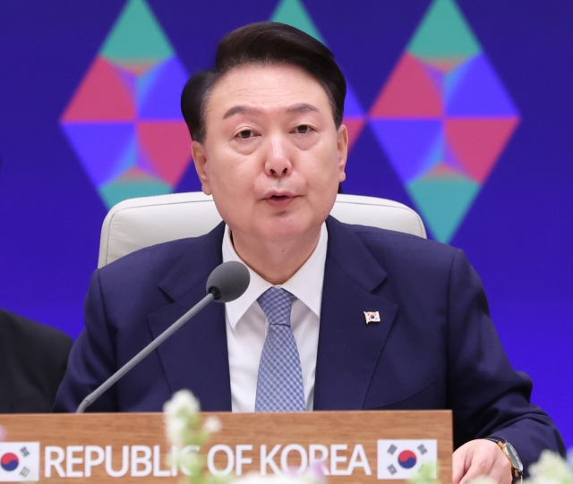 President Yoon Suk Yeol speaks during a trilateral summit held atheld at the guesthouse of the former presidential office, Cheong Wa Dae, in Seoul on Monday. (Yonhap)