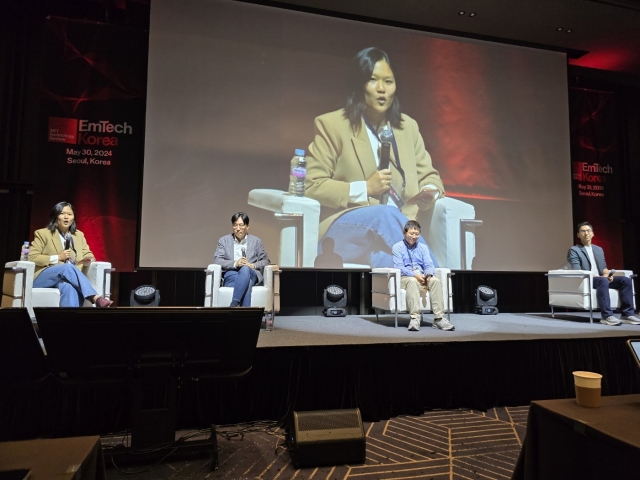 Karen Hao (far left), a contributing writer for The Atlantic, speaks during a discussion session, titled 