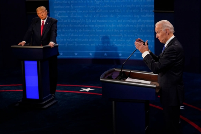 US President Joe Biden answers a question as Former President Donald Trump listens during the second and final presidential debate at Belmont University on October 22, 2020 in Nashville, Tennessee. (Getty images)