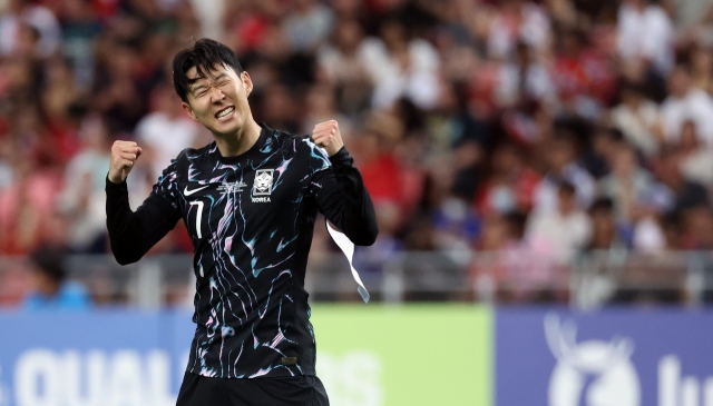 Son Heung-min of South Korea celebrates after scoring against Singapore during the teams' Group C match in the second round of the Asian World Cup qualification at the National Stadium in Singapore on Thursday. (Yonhap)