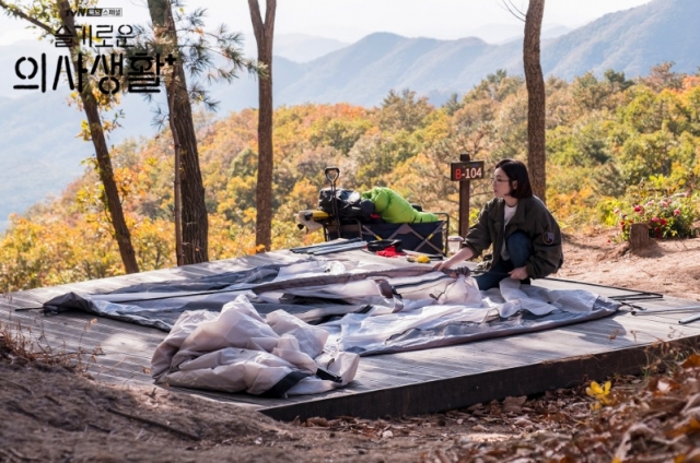 Chae Song-hwa, a neurosurgeon, sets up her tent at Seolmaejae Natural Recreation Forest in 