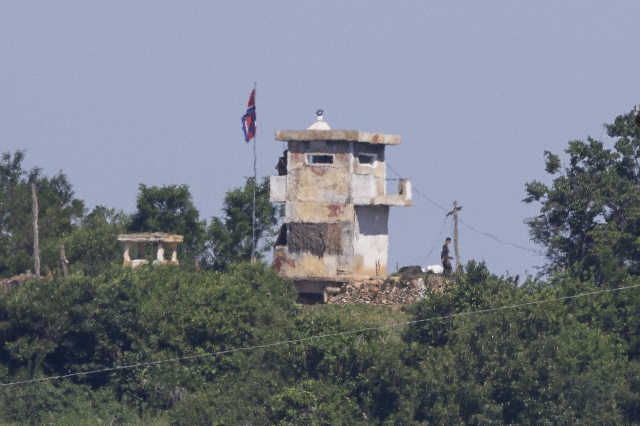 A North Korean soldier stands guard at a border outpost in this photo taken on Monday, from South Korea's border city of Paju, 37 kilometers northwest of Seoul. (Yonhap)