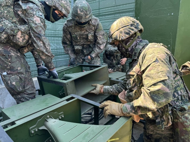 This photo provided by South Korea’s Joint Chiefs of Staff on Sunday shows loudspeakers being moved and installed along the inter-Korean border during a recent “Echo of Freedom” exercise. (Joint Chiefs of Staff via Yonhap)