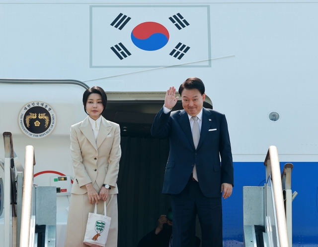 President Yoon Suk Yeol (Right) and First Lady Kim Keon Hee bid farewell at Seoul Air Base in Seongnam, south of Seoul, Monday, ahead of their state visit to Central Asia. (Yonhap)