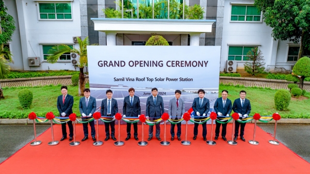 Kim Jung-hun, managing director of SK Ecoplant (fourth from left), and Lee Sang-hoon, general manager of Samil Vina (third from left), along with other attendees, pose for a photo during the completion ceremony held at the Samil Vina factory in Dong Nai province, Vietnam, Monday. (SK Ecoplant)