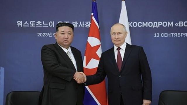 North Korean leader Kim Jong-un (left) shakes hands with Russian President Vladimir Putin ahead of their talks at the Vostochny Cosmodrome space launch center in the Russian Far East on Sept. 13, 2023,