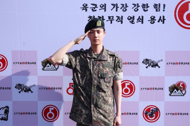 Jin of BTS salutes as he is discharged from the Army in Yeoncheon, Gyeonggi Province, Wednesday. (Big Hit Music)