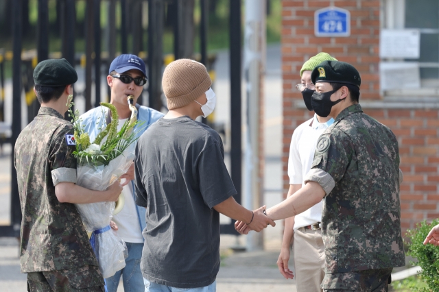 BTS' members congratulate Jin for getting discharged from the Army in Yeoncheon, Gyeonggi Province, Wednesday. (Yonhap)