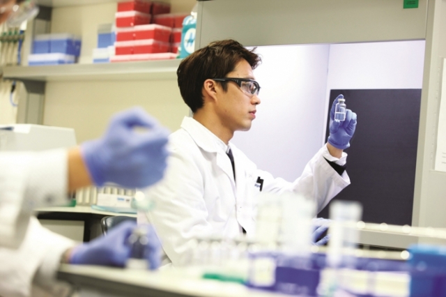 A Celltrion researcher is holding a drug vial. (Celltrion)