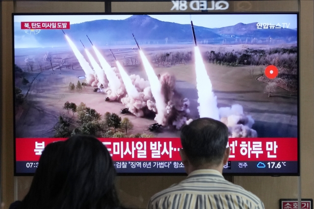 People watch a news program broadcasting a file image of a missile launch by North Korea, at the Seoul Railway Station in Seoul, South Korea, Thursday, May 30, 2024. (AP)