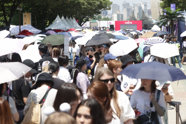 Fans of K-pop sensation BTS wait in line to attend 2024 BTS Festa, an annual event hosted by BTS' agency, BigHit Music, to celebrate the band's debut anniversary, at the Seoul Sports Complex in southern Seoul on Thursday. (Yonhap)