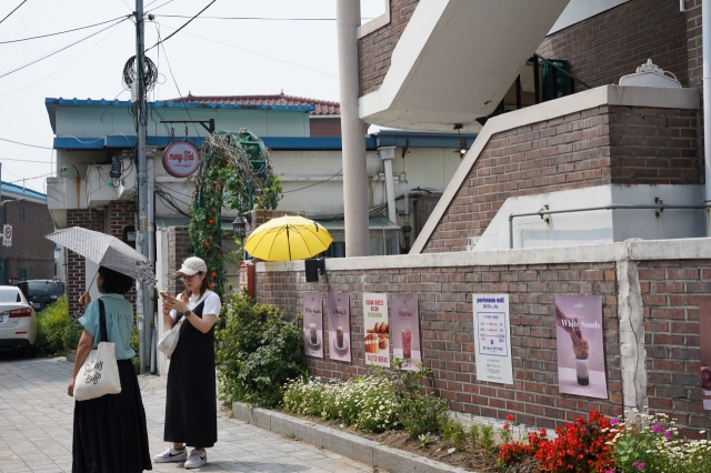 Tourists visit cafe Mong Ted, where Im Sol lives in 