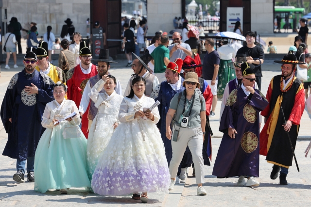 Tourists dressed in hanbok tour Gyeongbokgung in downtown Seoul on Thursday. According to the Korea Tourism Organization, the number of tourists visiting the country from overseas stood at 4.86 million for the first four months of the year, nearing pre-pandemic levels. (Yonhap)