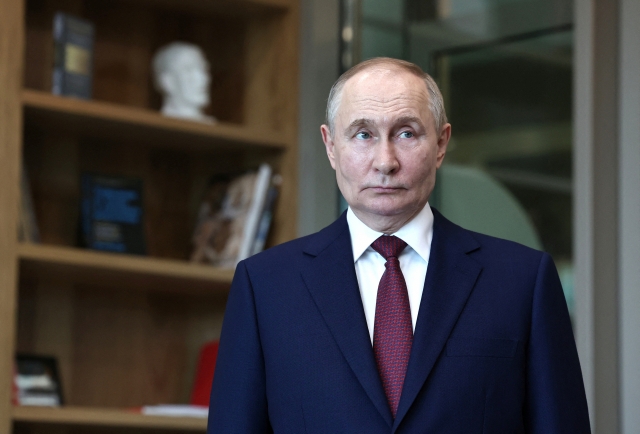 Russia's President Vladimir Putin visits Senezh Management Workshop before a meeting with participants of the 