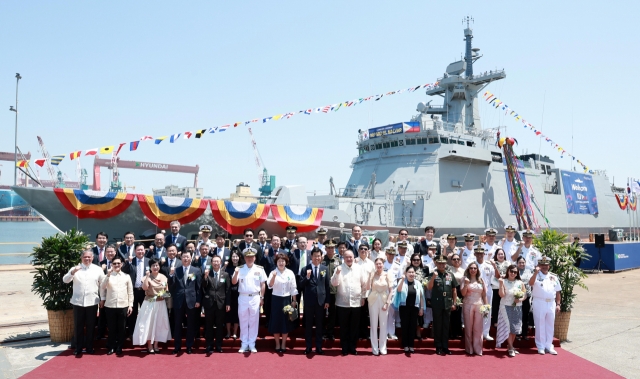 Philippine Secretary of National Defense Gilberto C. Teodoro Jr. (front row, seventh from right), HD Hyundai Heavy Industries CEO Lee Sang-kyun (front row, eighth from right), and other officials pose at the launch of the Philippine corvette Miguel Malvar in Ulsan on Tuesday. (HD Hyundai)