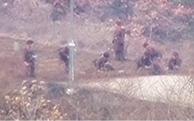 North Korean soldiers are seen at work near the border with the South in this photo taken June 18. (Yonhap)