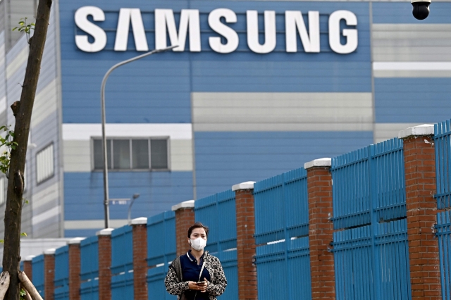 A woman walks past the Samsung Electronics factory in Vietnam's Bac Ninh province on June 11. (AFP)