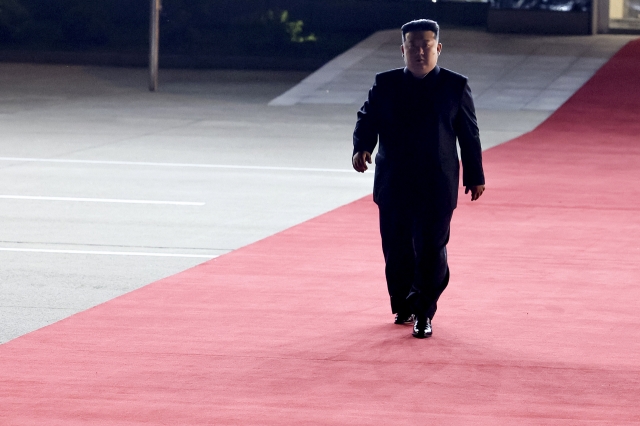 North Korea's leader Kim Jong-un walks to meet Russian President Vladimir Putin at the Pyongyang Sunan International Airport outside Pyongyang, North Korea, on June 19. (Kremlin Pool Photo via AP)