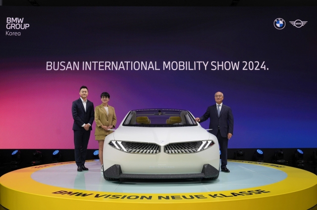 BMW Group Korea officials including President Han Sang-yun (right) pose for a photo with the BMW Vision Neue Klasse at the 2024 Busan International Mobility Show on Thursday. (BMW Group Korea)