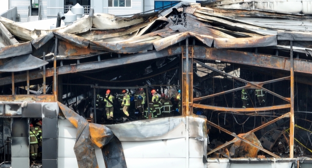 A joint forensics investigation takes place at Aricell, a lithium battery manufacturing plant in Hwaseong, Gyeonggi Province, Tuesday, a day after a fire broke out in the factory. (Yonhap)