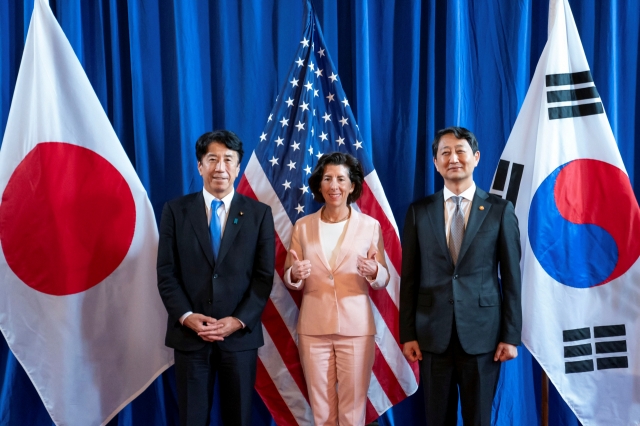 South Korea's Minister of Trade, Industry and Energy Ahn Duk-geun, US Commerce Secretary Gina Raimondo and Japan'ss Economy, Trade and Industry Minister Ken Saito pose for a press photo during the inaugural Trilateral Commerce and Industry Ministerial Meeting at the Commerce Department in Washington, US, Wednesday. (Reuters)