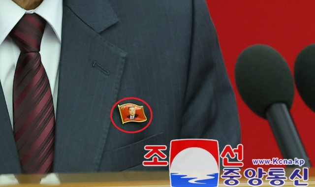 Officials wear a pin featuring the portrait of North Korean leader Kim Jong-un at a plenary meeting of the Workers' Party's central committee in Pyongyang on Saturday, in this photo provided by the North's official Korean Central News Agency the following day. (Yonhap)